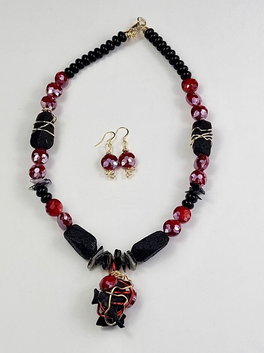 Black lava stone beaded necklace with red crystal accents.