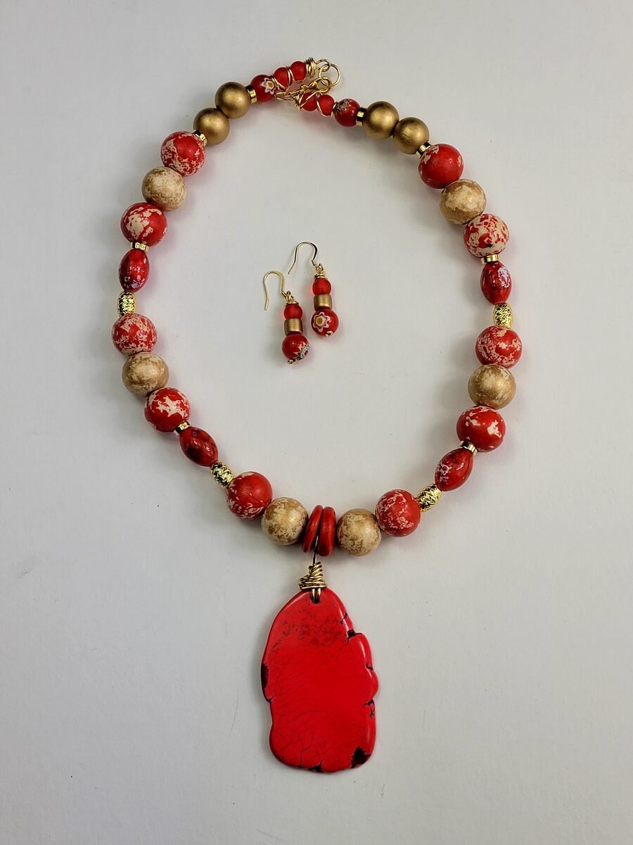 Rich red jasper beaded necklace with sand-colored speckled accents and gold spacers, matching earrings.