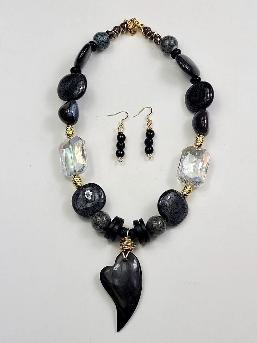 Black beaded necklace with a smoky heart pendant.