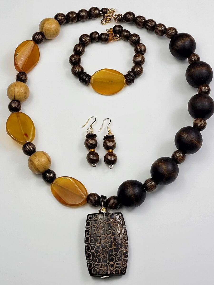 Dark wood beaded necklace with carved amber accents.