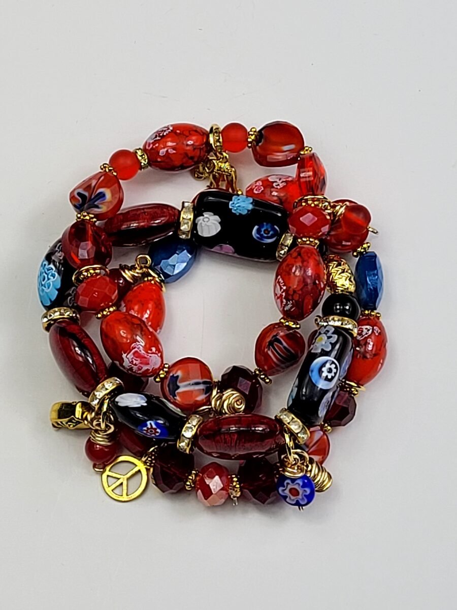 Red and black floral beaded bracelet with peace charm.